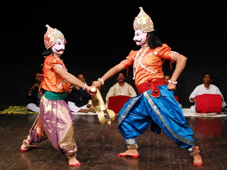 two masked performers in a play fighting each other