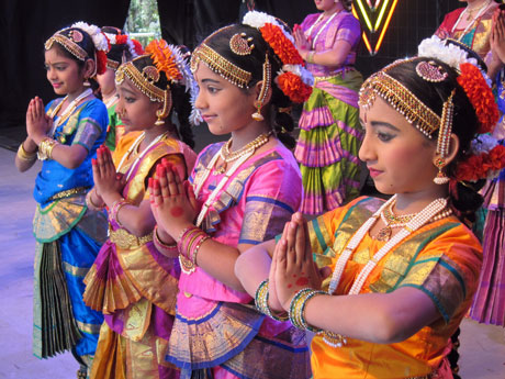 four performers praying at the festival